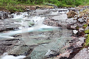 Mountain beautiful waterfall cascades with flowing clear water from tops