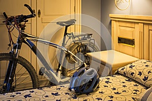 Mountain bicycle and a helmet in a hotel room - Bicycle touring