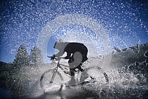 Mountain Bicyclist Splashing Through Water