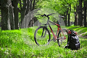 Mountain bike, backpack and helmet on a trail in the forest