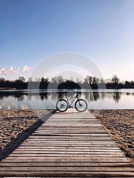 Mountain bike on the beach against colorful sunset