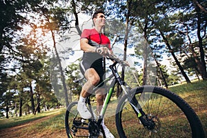 Mountain bike cyclist riding trail in forest