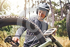 Mountain bike, fitness or cyclist fixing chain in exercise, training or workout in Norway forest or nature woods