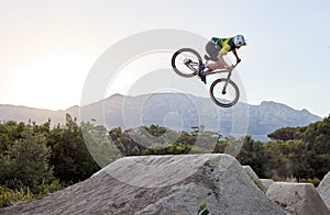 Mountain bike, jump and man doing extreme stunt while training or riding in competition. Bicycle, sports and athlete or