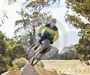 Mountain bike man, air ramp and outdoor with helmet, extreme sport and focus for fitness, speed and training. Bmx