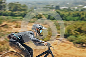 Mountain bike, man and race for speed, dirt or nature in summer for mock up, extreme sport or motion blur. Bicycle