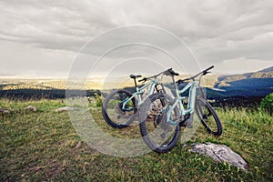 Mountain bike parked on a mountain summit with a great and clear view to the surrounding landscape