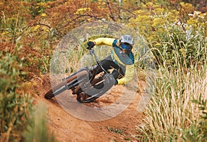 Mountain bike race, man and cycling adventure on dirt path, sand hill and speed challenge, sports action or fast athlete