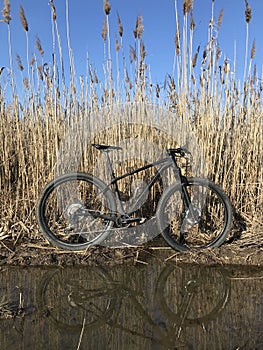 Mountain bike with reflection in the water