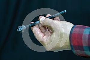 mountain bike repair. Bike mechanic in the workshop. Mechanic holds the axle in his hand from the back of the bike bushing. Hand