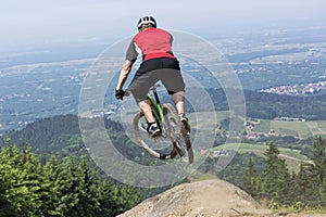 Mountain bike rider jumping precipice photo