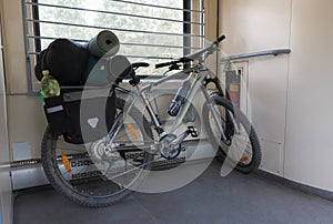 Mountain bike with saddlebags is transported in the train.