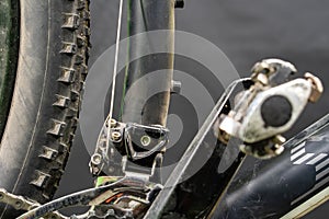 Mountain bike in the workshop. Pedal and front derailleur close-up. An active lifestyle using a serviceable bicycle