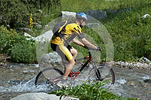 Mountain biker and creek photo