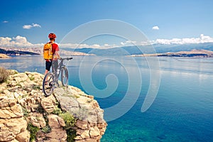 Mountain biker looking at view and riding a bike