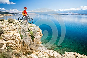 Mountain biker looking at view and sea