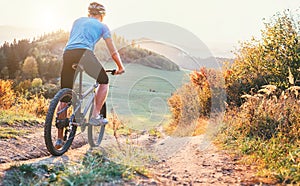 Mountain biker ride down from hill. Active and sport leisure con