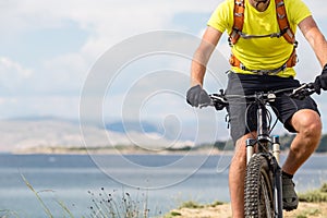 Mountain biker riding on bike at the sea