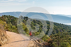 Mountain biker riding on bike at the sea