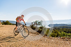 Mountain biker riding on bike at the sea
