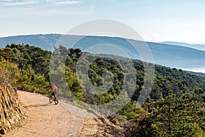 Mountain biker riding on bike at the sea