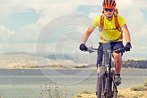 Mountain biker riding on bike at the sea