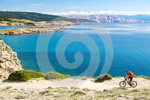 Mountain biker riding on bike at seaside path