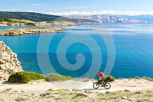 Mountain biker riding on bike in summer sunset woods