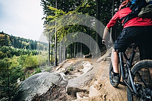 Mountain biker riding cycling in autumn forest