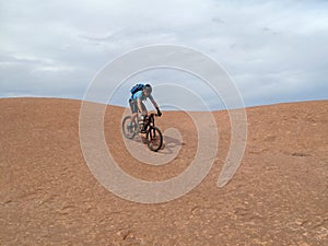 Mountain biker riding downhill the famous Slickrock trail, Moab, USA