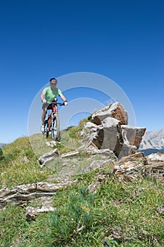 Mountain biker riding downhill in Swiss Alps