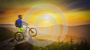 Mountain biker riding at sunset on bike in summer mountains fore