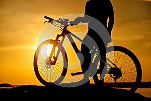 mountain biker silhouette in sunrise. Active Lifestyle Concept