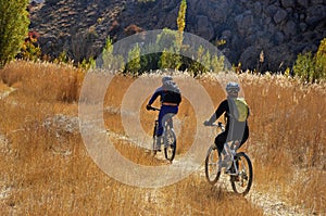 Mountain bikers biking in Alborz mountains during colorful autumn