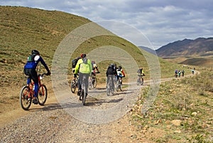 Mountain bikers group racing in desert