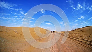 Mountain bikers riding the bike in a desert road