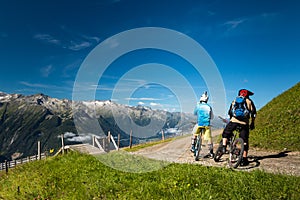 Mountain bikers riding enduro trail in the alps