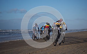 Mountain bikers taking part in the beach race Egmond-Pier-Egmond ride along the sea shore