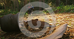 Mountain biking couple riding in the forest on a sunny day