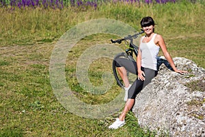 Mountain biking happy sportive girl relax in meadows sunny countryside