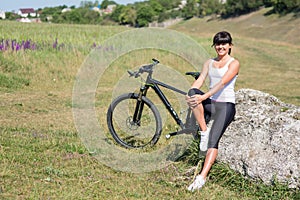 Mountain biking happy sportive girl relax in meadows sunny countryside