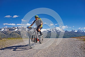 Mountain biking in the high mountains on a dirt road