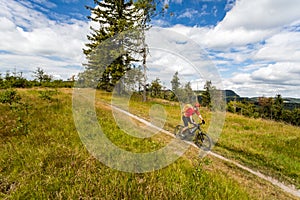 Mountain biking man riding in woods and mountains