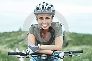 Mountain biking - woman with fatbike enjoys summer vacation. Close up photo