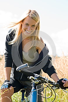 Mountain biking young woman sportive sunny meadows