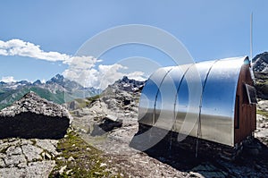 Mountain bivouac free sleeping shelter in the piedmontese alps Italy, facing the Mount Viso