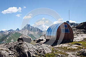 Mountain bivouac free sleeping shelter in the piedmontese alps Italy, facing the Mount Viso