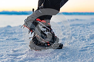 Mountain Boot with crampons on while hiking in the mountains in winter.