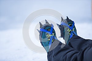 Mountain boots with crampons on the ice.