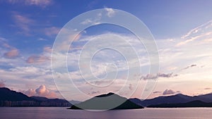 Mountain, building, dramatic sky and sea at sunset